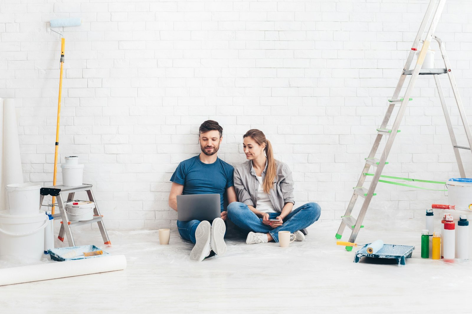 Young couple using laptop during home improvement